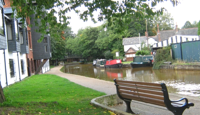 a canal next to smart houses and plenty of trees in worsley